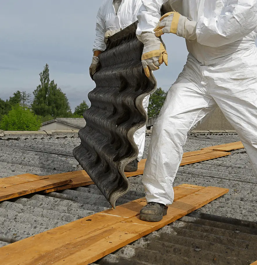Asbestos abatement professional inspecting wall materials in Salt Lake City