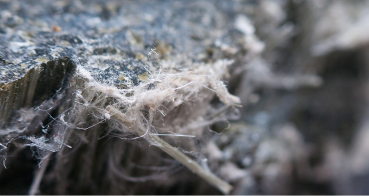 Close-up of old asbestos roofing tiles in deteriorating condition