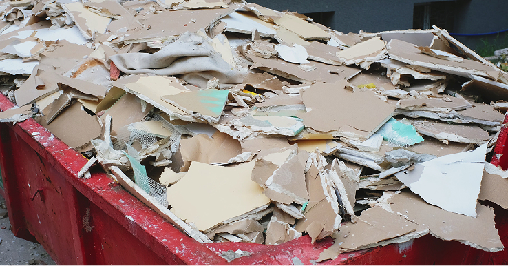 Hazardous material workers clearing asbestos debris at a Utah demolition site