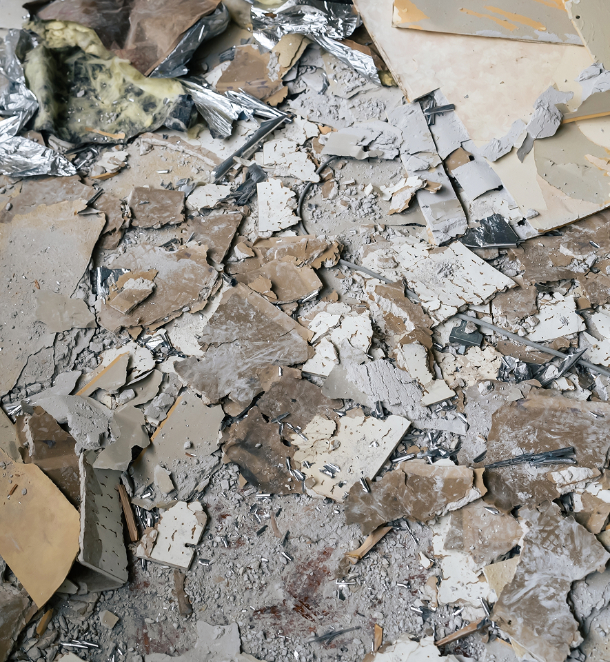 Demolished building with asbestos waste materials being managed on site