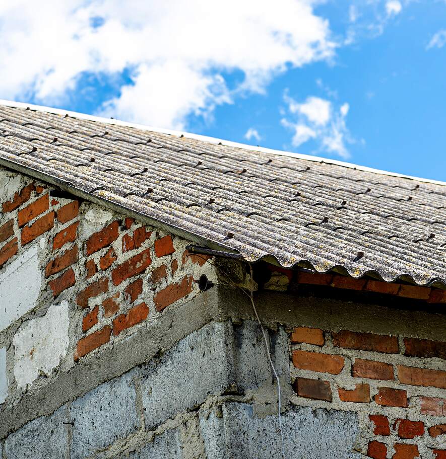 Aged building exterior with weathered materials that may contain asbestos