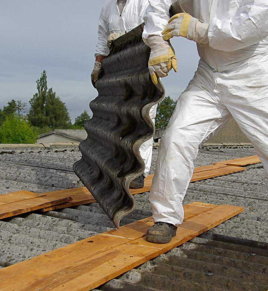 Damaged asbestos-containing roof tiles requiring professional inspection