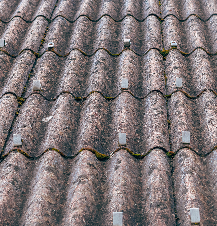 Corrugated asbestos roof showing visible signs of deterioration requiring testing